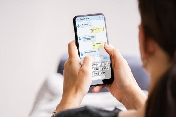 a woman holding a smart phone in her hands