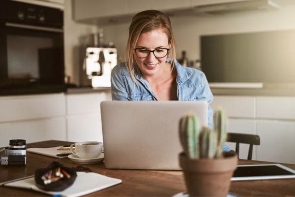 a woman sitting in front of a laptop computer